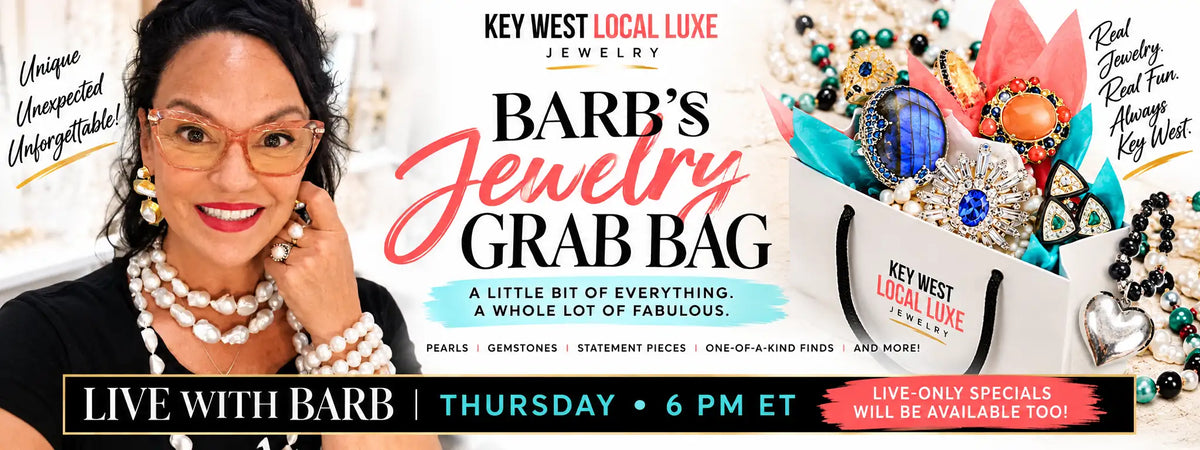 White paper shopping bag with ’key west local luxe jewelry’ printed in red and black text.
